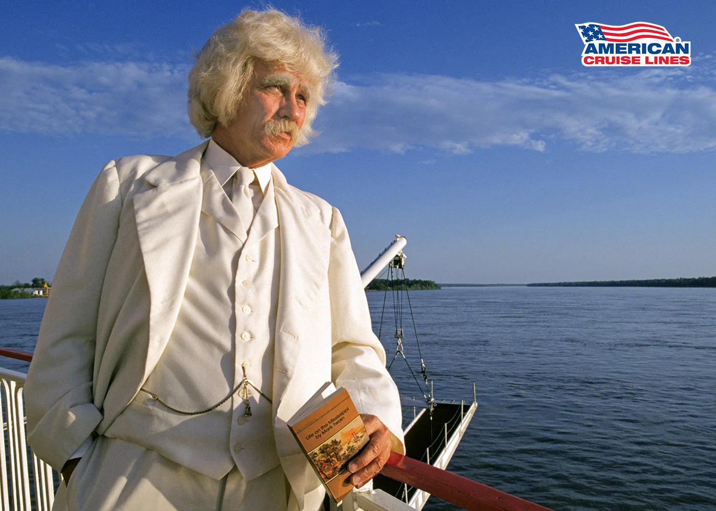 Mark Twain costumed performer on deck of an American Cruise Lines Mississippi riverboat